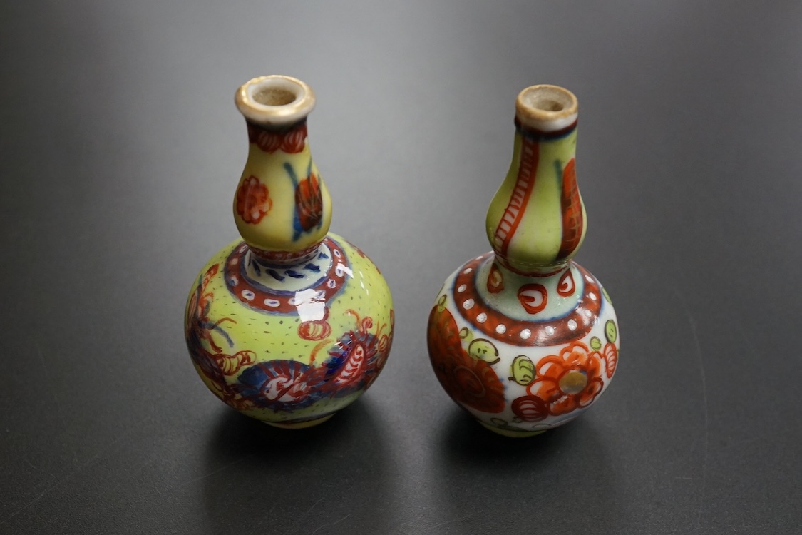 Two Chinese famille rose cups, Yongzheng period and two miniature clobbered vases, largest 6cm high